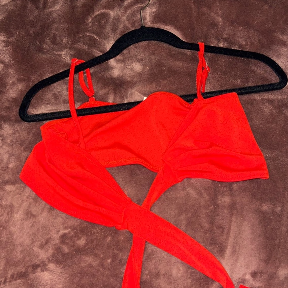 Red crossover top, it can be tied in the back or front but it wraps around chest